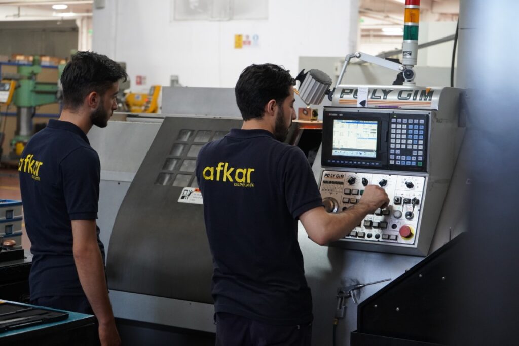 Mold design engineer configuring EDM machine